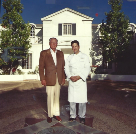 Two men standing in front of a building.